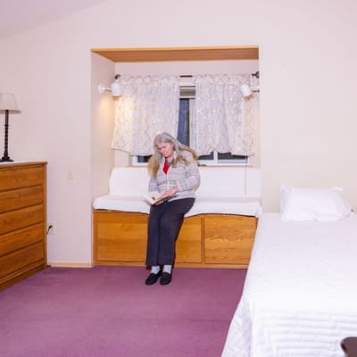 Resident reading in a well-lit room
