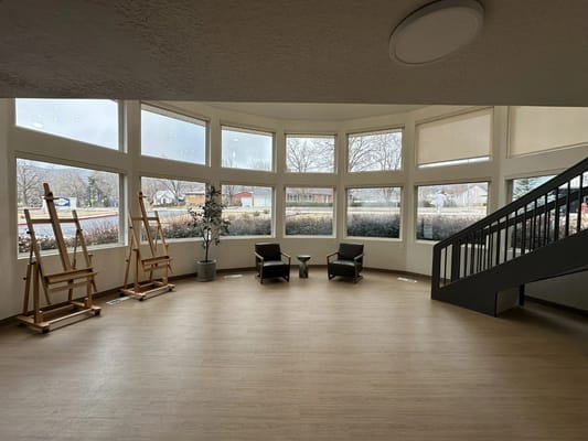 Bright common area with seating and large windows