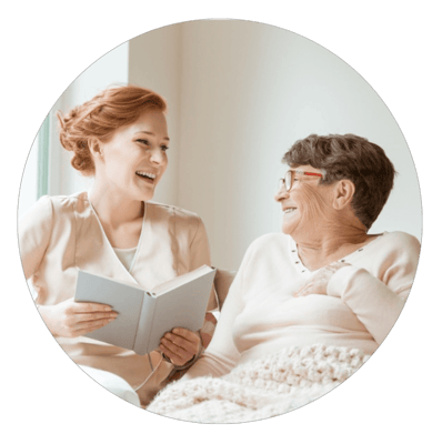 A caregiver sharing a joyful moment with a resident