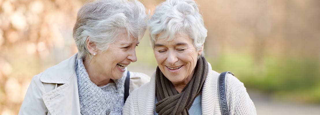 Two residents enjoying a walk in the garden