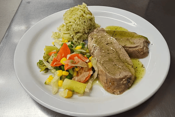 Plate of meat with vegetables and rice