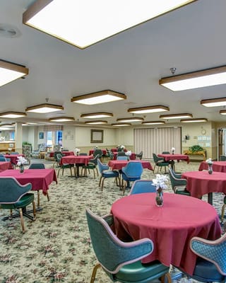 Bright dining room with tables and floral centerpieces
