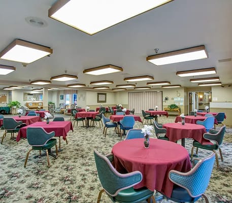 Dining area with round tables and flower arrangements