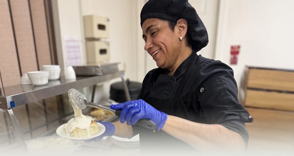 Staff serving food in a dining area