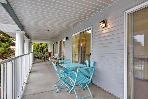 Bright shared common area with seating and tables