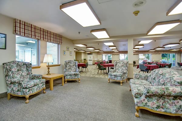 Common area with floral furniture and dining setup
