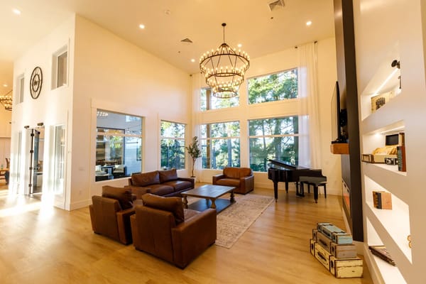Bright common area with large windows and comfortable seating