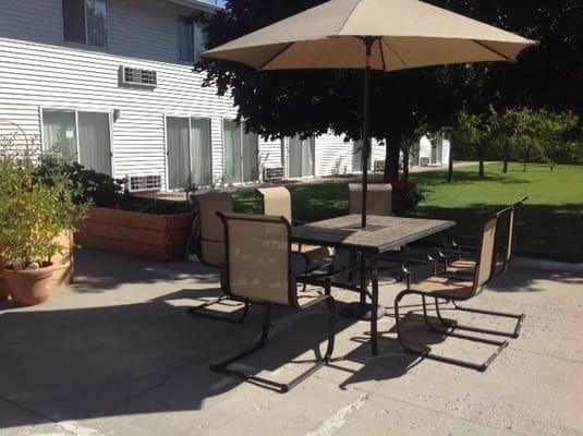 Outdoor seating area with umbrellas and garden
