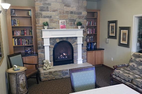 Cozy common area with a fireplace and bookshelves