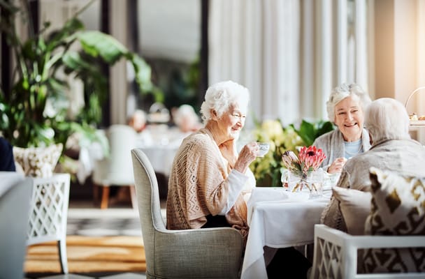 Residents enjoying tea in a bright dining room