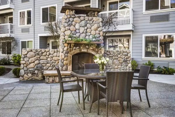 Outdoor seating area with stone fireplace