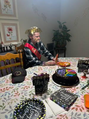 Resident celebrating birthday with cake and decorations
