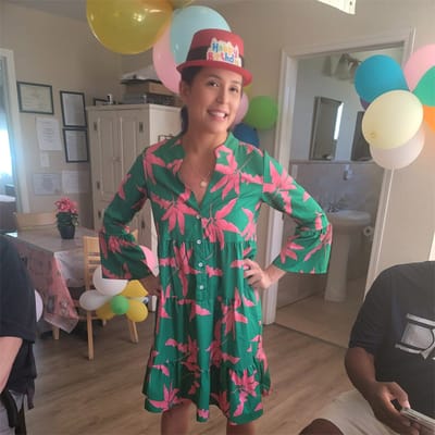 A resident celebrating a birthday in a festive room