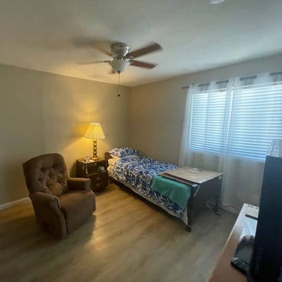 Cozy private bedroom with a bed and armchair