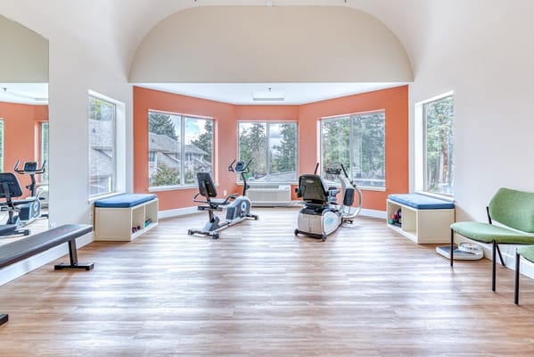 Brightly lit fitness room with exercise equipment