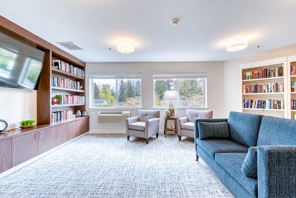 Bright and inviting common area with seating and bookshelves