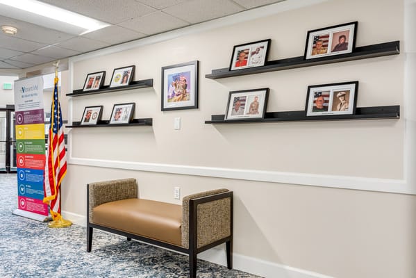 Interior hallway with framed photographs and an American flag