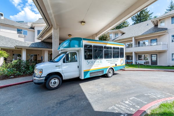 Facility transport van parked under an overhang