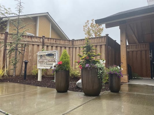 Welcoming outdoor entrance with flower pots at the Cottages of Renton