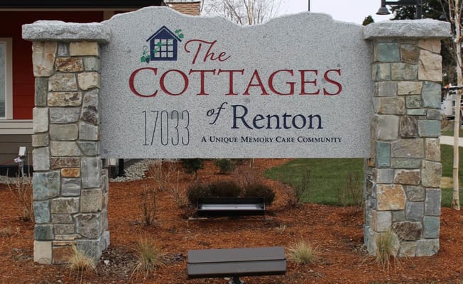 Signage for The Cottages of Renton with natural stone background