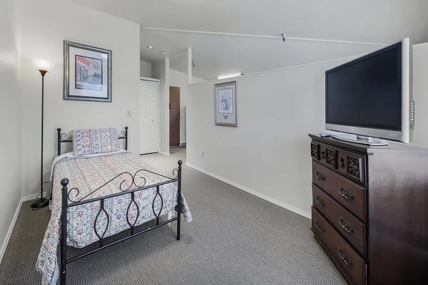 A private resident room with a bed and TV
