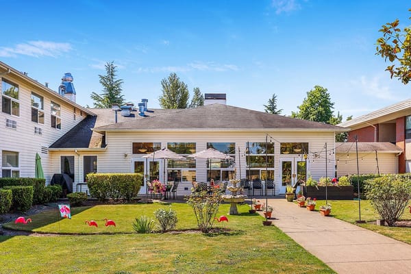 Outdoor patio area with gardens and seating