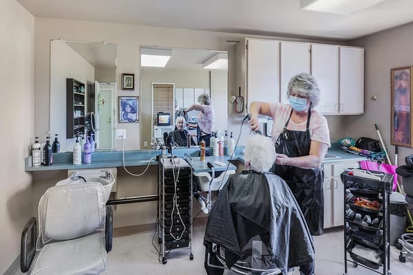 Resident receiving hair treatment in a salon