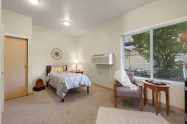 Cozy private resident room with bed and seating area