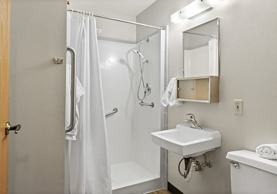 A clean, accessible bathroom with grab bars