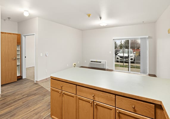 Empty room in a senior living facility with a window view