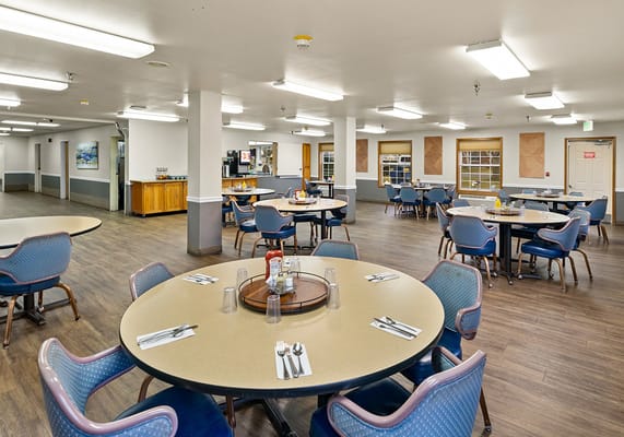 Dining area with tables and chairs for residents