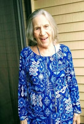 Resident smiling in a colorful outfit