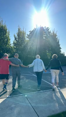 Residents and staff walking together outdoors
