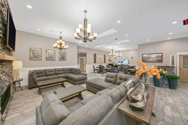 Common area with seating and decor in a senior living facility