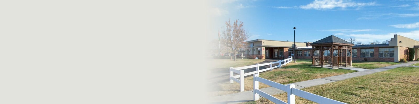 Exterior view of a senior care facility with gazebo