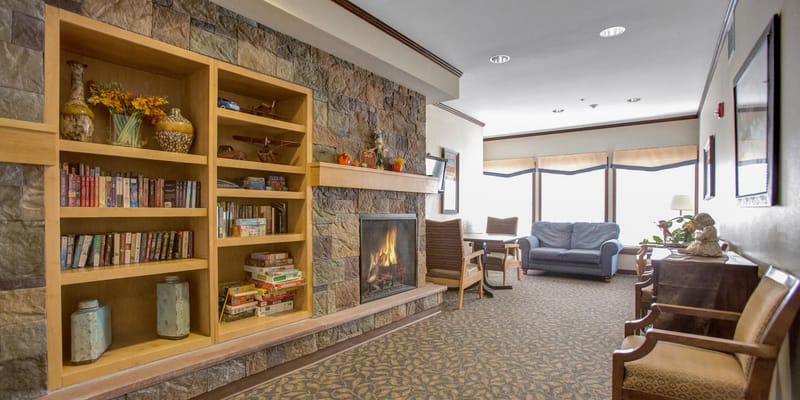 Warm common area with bookshelves and seating