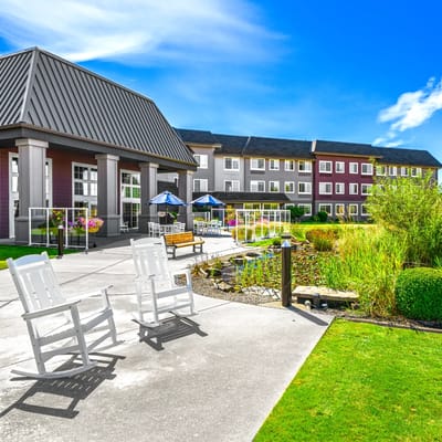 Outdoor patio with rocking chairs and gardens
