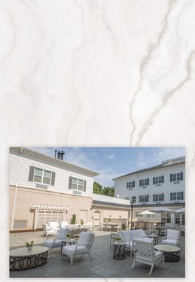 Outdoor seating area with tables and chairs