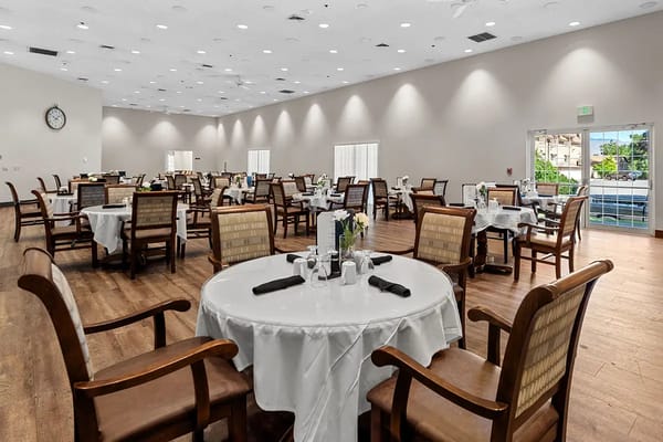 Spacious dining room with tables set for meals