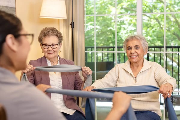 Residents participating in a group exercise session indoors