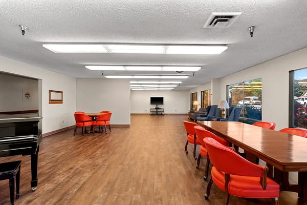 Common area with seating and piano in facility