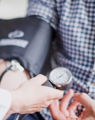 A healthcare professional taking a resident's blood pressure