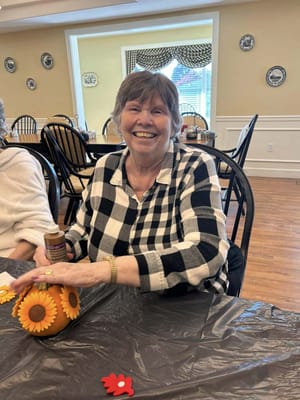Resident engaged in a craft activity in common area