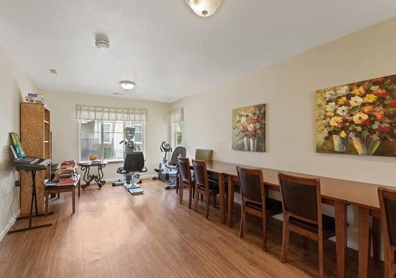 Bright common area with tables and artwork