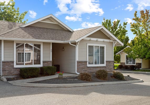 Exterior view of a senior living building with landscaping