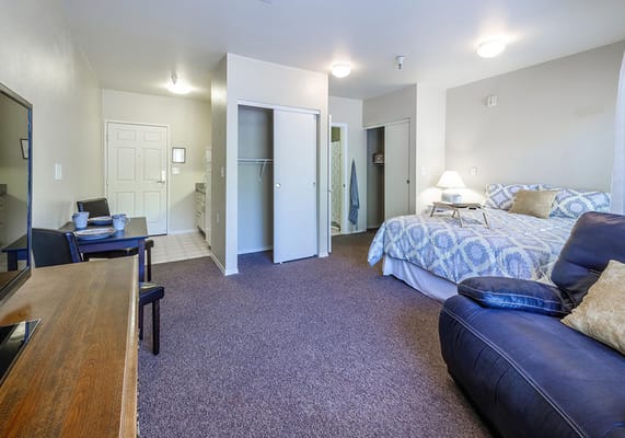 Cozy resident room with a bed and seating area