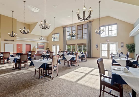 Bright dining room with tables set for meals