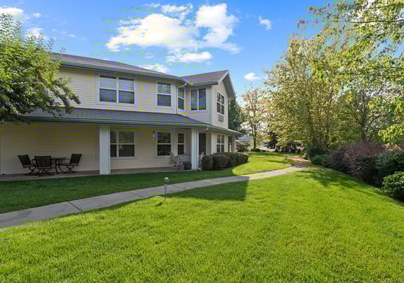 Exterior view of a senior living facility with green spaces