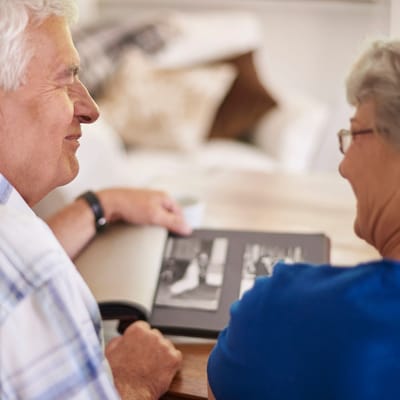 Seniors looking at a photo album together