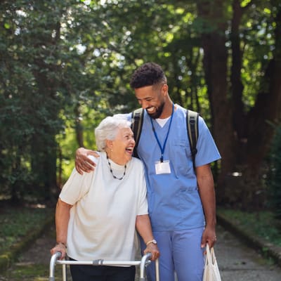 A caregiver and a resident enjoying time outdoors